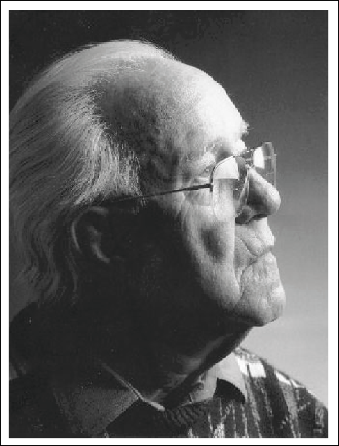 A black and white photo of an older man with glasses.