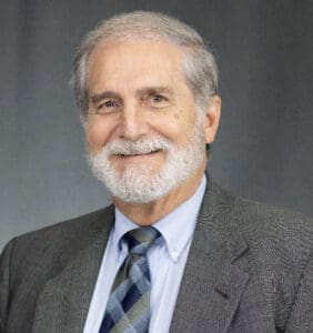 A man with a beard and suit jacket